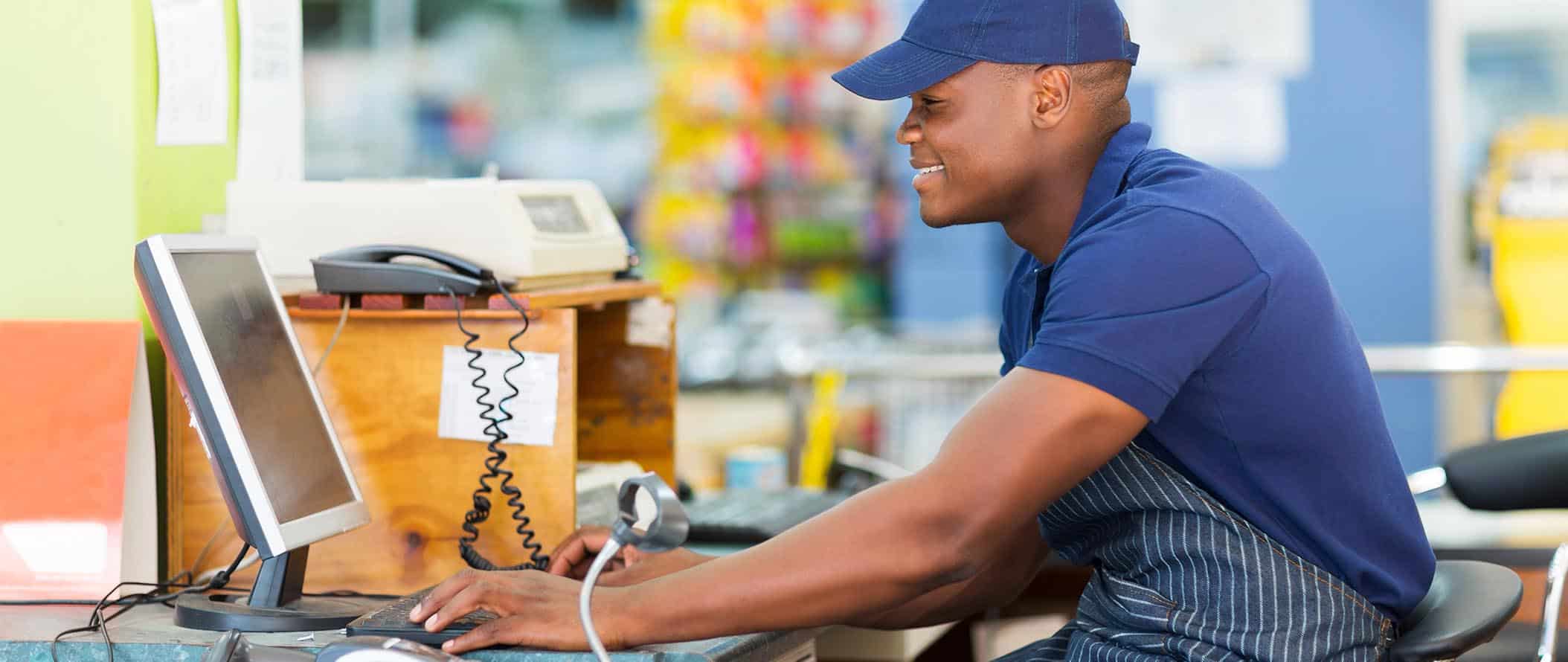 ret male cashier working at store banner